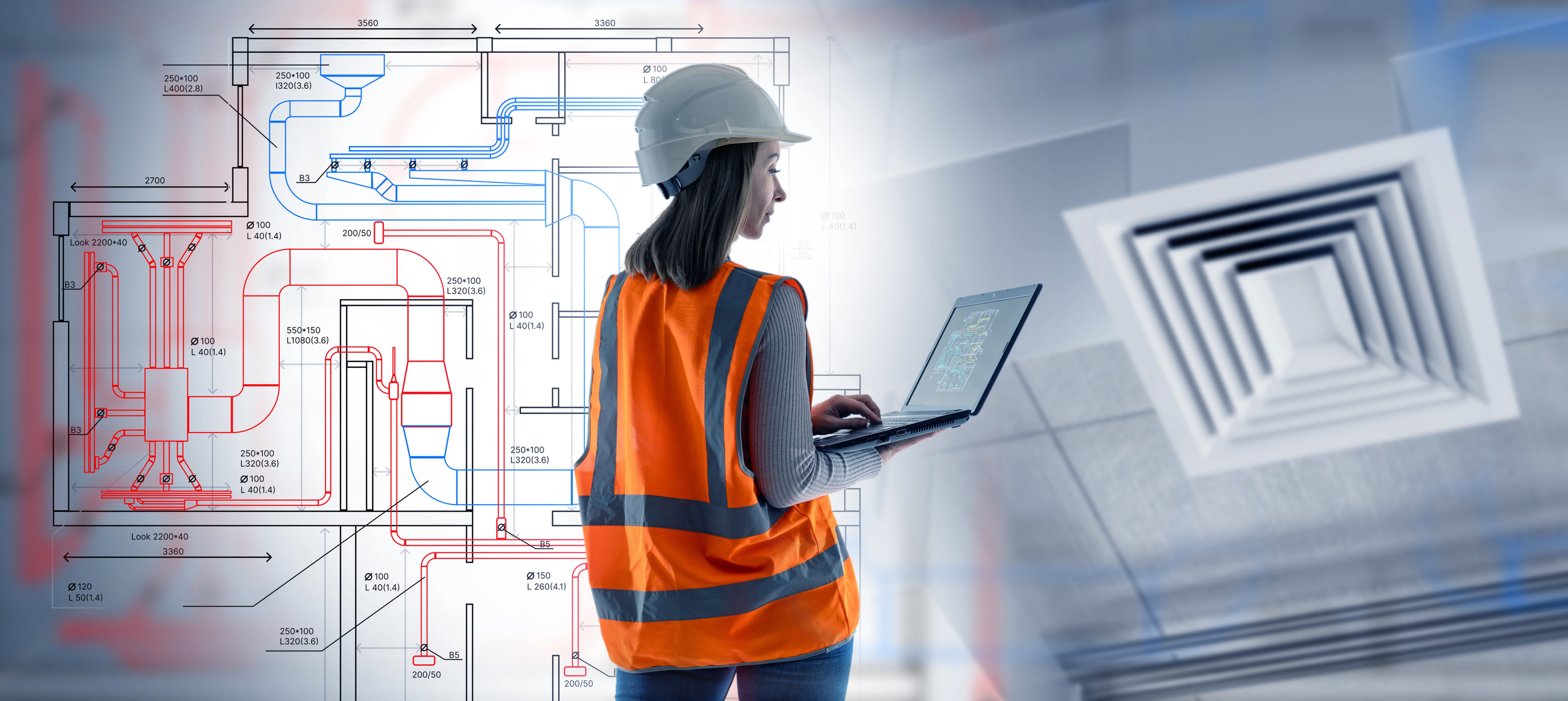 Person in safety gear using a laptop with HVAC diagrams and a ceiling vent in the background