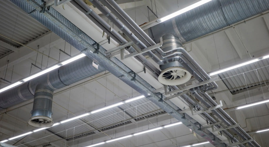 Ceiling with metallic pipes and ducts in a industrial setting